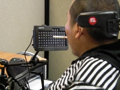 A consumer with paralysis uses a device which makes it possible to work a computer with his mouth.